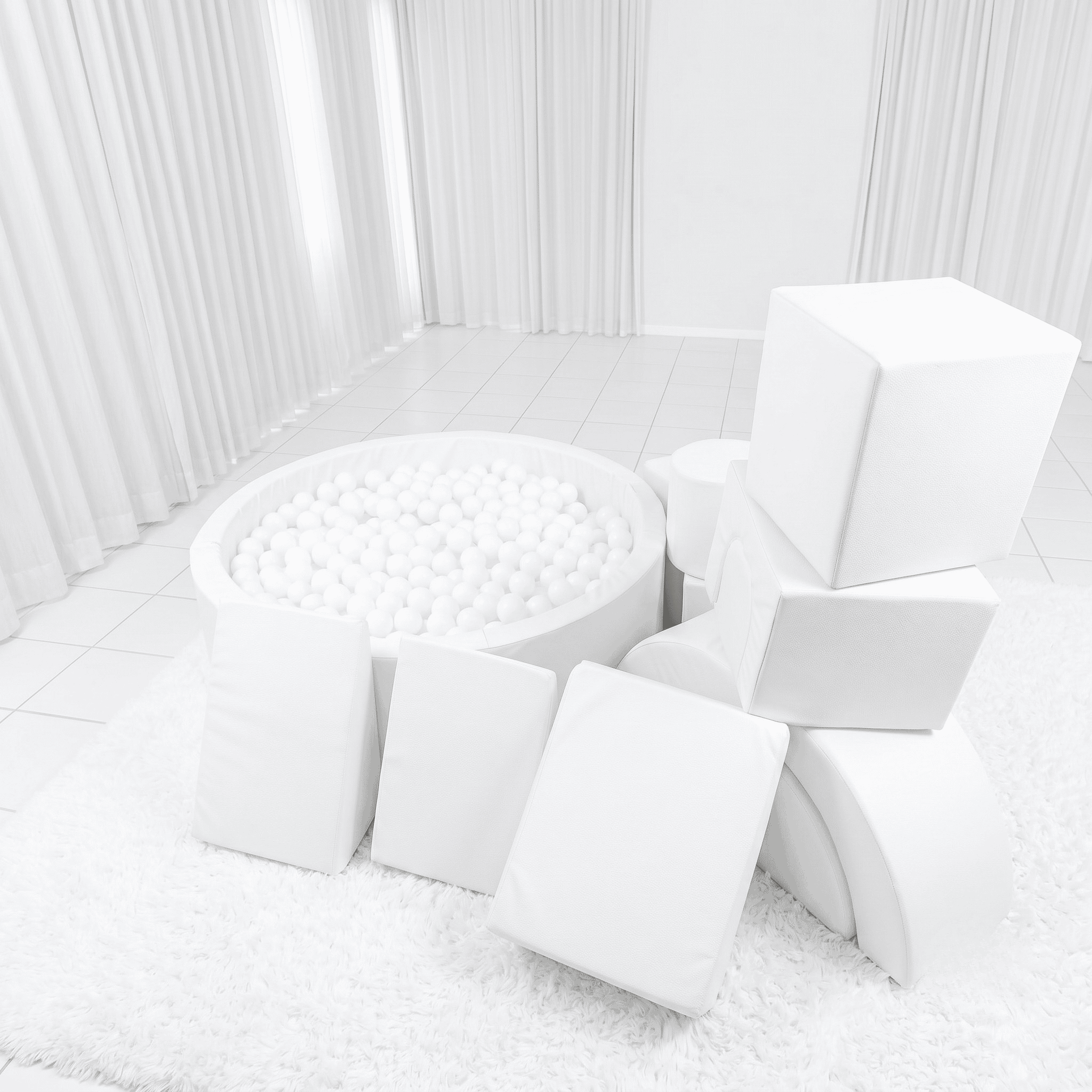 A luxury all-white soft play setup featuring a chic ball pit, white foam climbing blocks, and a mini slide on a clean white play mat